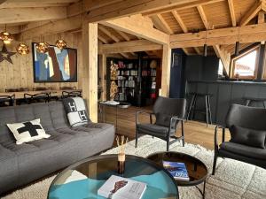 a living room with a couch and two chairs and a table at Chalet Fabriel in Montgenèvre