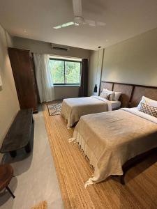 a hotel room with two beds and a window at Soul Nest-Pyramid Valley International Bengaluru in Bangalore