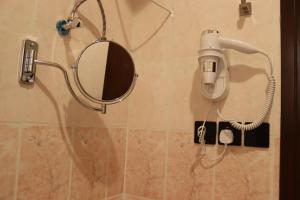 a mirror and a hair dryer on a bathroom wall at طيف المكان للشقق الفندقية in Riyadh