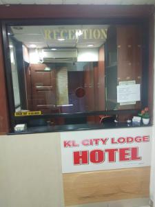 a kl city lodge hotel sign in front of a window at KL CITY LODGE in Kuala Lumpur