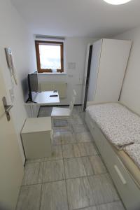 een kleine kamer met een bed en een bureau bij Kleine Wohnung für Singles in Daun