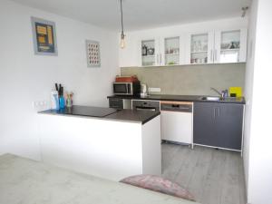 a kitchen with white cabinets and a counter top at Ferienwohnung Rackl in Furth im Wald