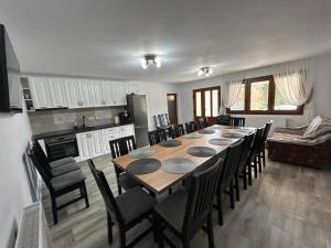 a kitchen and dining room with a table and chairs at CABANA VALEA POPII in Sita Buzăului