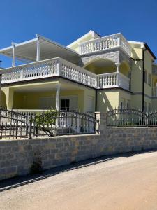 a house with a balcony on a stone wall at Villa Georgina in Vodice