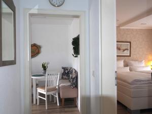 a bedroom with a bed and a table and a chair at Apartment Schlossblick - Top location in Idar-Oberstein