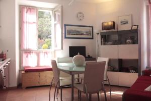 a living room with a table and chairs at VECCHIA STAZIONE - by Satisfactual Property in Menaggio
