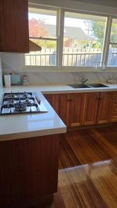 a kitchen with a stove and a counter top at Pakenham Villa in Pakenham