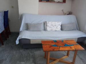 a living room with a couch and a table at KATY&MLADEN in Baška