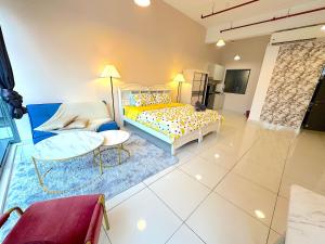 a bedroom with a bed and a couch and a table at 3 Towers Jalan Ampang By Serenity Vacation Homes in Kuala Lumpur