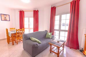 a living room with a couch and a table at Apartamento junto la playa in Gran Tarajal