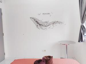a drawing on the wall of a room with a couch at Camellia Residence ForestView 2BR 4Paxs near Seri Austin Mount Austin Johor Bahru in Johor Bahru