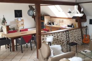 a kitchen and dining room with a table and chairs at Paradis nature dans Le PERCHE - Vue, Confort, Pêche, Étang, Salle de Sport, à 5min Ville & Gare in Belhomert-Guéhouville +58 photos