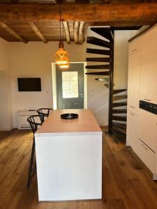 a kitchen with a white island in a room at CASA SAN MATTEU in Patrimonio