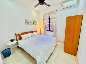a bedroom with a white bed with flowers on it at JB-Bukit Indah 8-15pax Spacious Home! 5min to Aeon in Johor Bahru