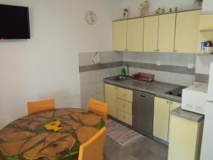 a kitchen with a table and chairs in a room at KATY&MLADEN in Baška