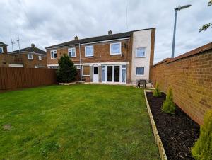 a house with a lawn in front of it at 6 Guests * 4 Bedroom * Free Wi-Fi *Huntingdon in Huntingdon