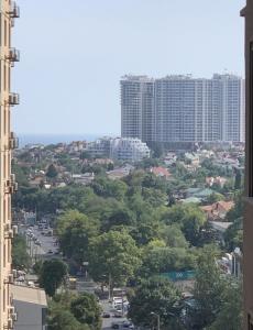 a view of a city with tall buildings and trees at Apartments near the sea in Odesa