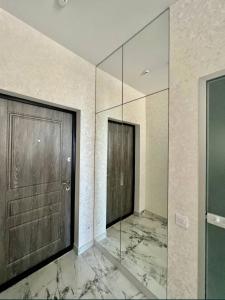 a glass hallway with a door and a wall at Apartments near the sea in Odesa