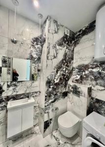 a bathroom with a black and white marble wall at Apartments near the sea in Odesa