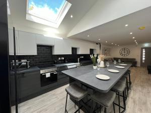 a large kitchen with a table and some chairs at We House One - Birmingham in Birmingham
