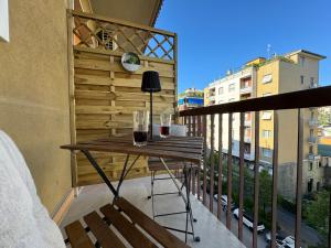 a balcony with a table and glasses of wine at MEG Glamour Suite in Milan