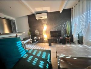 un soggiorno con un divano e una TV di Bel appartement à 5 minutes de la plage a Cap d'Agde