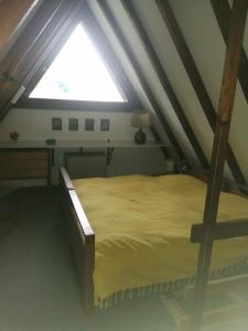 a bedroom with a large bed in a attic at Ferienhaus Bergwiese in Siegsdorf