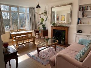 a living room with a couch and a table at Bright new flat in Battersea in London