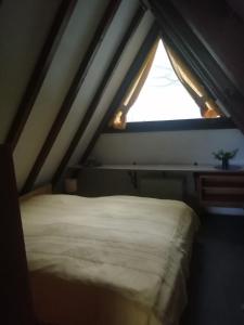 a bed in a room with a window at Ferienhaus Bergwiese in Siegsdorf