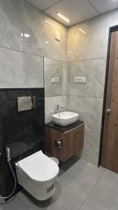a bathroom with a toilet and a sink at Hotel Holiday Icon in Dwarka