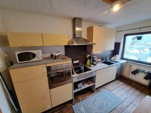 a small kitchen with a sink and a microwave at Zum Jandel in Boppard