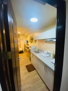 a kitchen with a sink and a counter at Pauline's Getaway near Nuvali Paseo Santa Rosa in Bayabasan