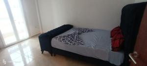 un piccolo letto in una camera da letto con struttura blu di F4 lpp Mostaganem Algérie a Mostaganem