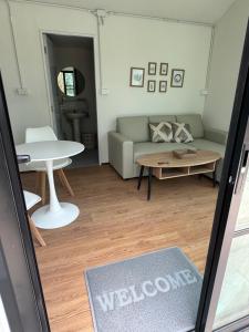 a living room with a couch and a table at Mayuree Homestay in Kranuan