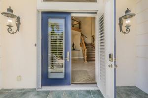 a blue door on a house with a staircase at Royal Palm House in Captiva