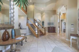 a living room with a staircase and a table at Royal Palm House in Captiva