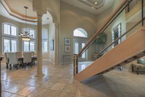 a dining room with a staircase in a home at Royal Palm House in Captiva