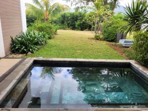 a swimming pool in the backyard of a house at La Mivoie Beachfront with Private Pool in Rivière Noire