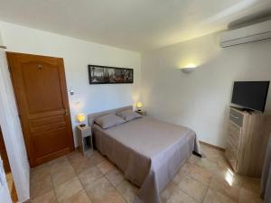 a bedroom with a bed and a flat screen tv at VILLA BIOT in Biot