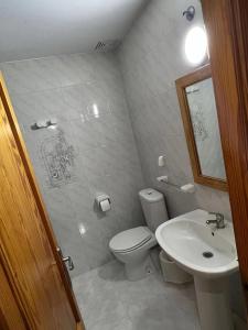 a bathroom with a toilet and a sink at ROOM IN THE CENTER FAMILY APARTMeNT in Manacor