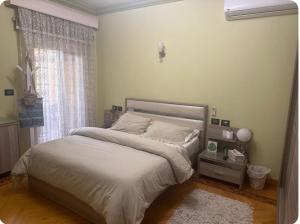 a bedroom with a bed and a window at Cozy room in Cairo