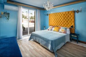 a bedroom with a large bed with a large yellow headboard at Casa Honey in Marbella