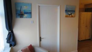 a white door in a room with a sail boat at The Wheatsheaf in Holt