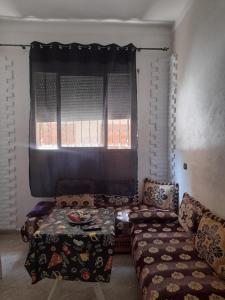 a living room with a couch and a window at Apartment Surf in Skhirat