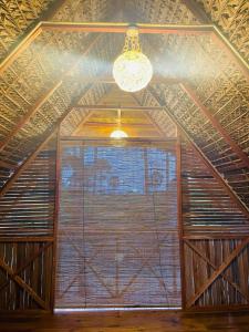 a large window in a room with a ceiling at Borassus Nature Huts in Jaffna