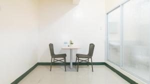 a dining room with a table and two chairs at RedDoorz @ Western Bicutan Transients Inn in Manila