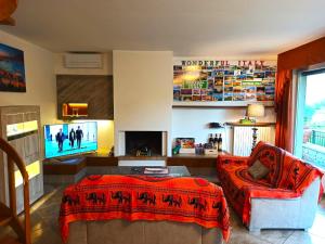 uma sala de estar com um sofá e uma televisão em Villa Merone - Pusiano Lake em Merone