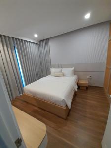 a small bedroom with a bed and a window at Villa Minh Châu in Bình Tú +30 photos