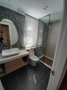 a bathroom with a toilet and a sink and a shower at Villa Minh Châu in Bình Tú