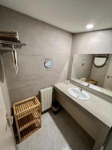 a bathroom with a sink and a mirror at Moulin de la Sambuc in Saint-Zacharie